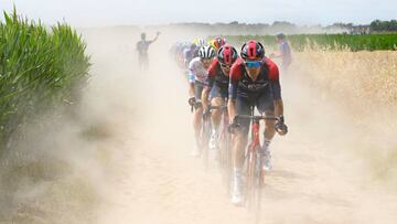 UAE Team Emirates team's Slovenian rider Tadej Pogacar (3rd R) wearing the best young rider's white jersey, Ineos Grenadiers team's British rider Geraint Thomas (2nd R) and Ineos Grenadiers team's Dutch rider Dylan Van Baarle (R) cycle across a cobblestone sector in the final kilometers of the 5th stage of the 109th edition of the Tour de France cycling race, 153,7 km between Lille and Arenberg Porte du Hainaut, in northern France, on July 6, 2022. (Photo by Bernard PAPON / POOL / AFP) (Photo by BERNARD PAPON/POOL/AFP via Getty Images)