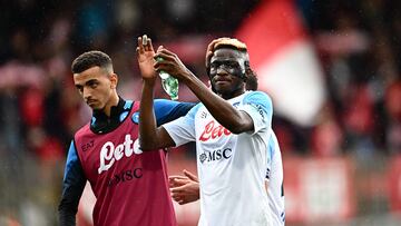 Napoli's Algerian defender Karim Zedadka (L) and Napoli's Nigerian forward Victor Osimhen acknowledge the public at the end of the Italian Serie A football match between Monza and Napoli on May 14, 2023 at the Brianteo stadium in Monza. (Photo by GABRIEL BOUYS / AFP)