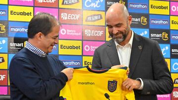 President of the selection commission of the Ecuadorian Football Federation Rodrigo Espinosa (L) hands over the team's shirt to the new head coach Spaniard Felix Sanchez (R) during a press conference on his presentation in Quito, on March 13, 2023. - Spaniard Felix Sanchez, the former Qatar coach, is taking over the Ecuador team, the national football federation (FEF) announced on Saturday. (Photo by Rodrigo BUENDIA / AFP)