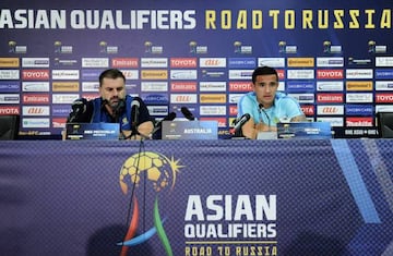 Australia's Tim Cahill (R) speaks beside football coach Ange Postecoglou during a press conference ahead of their 2018 World Cup qualifying football match between Syria and Australia
