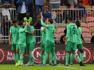 Real Madrid players celebrate after Isco nets the second goal against Valencia.