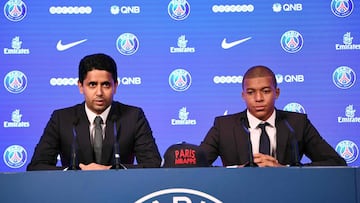 Paris Saint-Germain's new forward Kylian Mbappe (R) is presented by Paris Saint Germain's Qatari president Nasser Al-Khelaifi during a press conference at the Parc des Princes stadium in Paris on September 6, 2017.