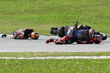 Monster Energy Yamaha MotoGP's French rider Fabio Quartararo (R) and Red Bull KTM Factory's Australian rider Jack Miller (L) fall after a collision during the MotoGP Malaysian Grand Prix at the Sepang International Circuit in Sepang on November 3, 2024. (Photo by MOHD RASFAN / AFP)