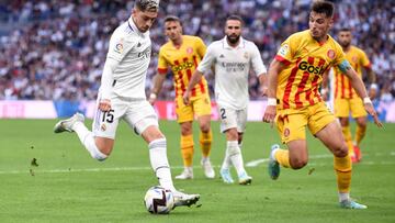 MADRID, SPAIN - OCTOBER 30: Federico Valverde of Real Madrid shoots while under pressure from Valery Fernandez of Girona FC during the LaLiga Santander match between Real Madrid CF and Girona FC at Estadio Santiago Bernabeu on October 30, 2022 in Madrid, Spain. (Photo by Denis Doyle/Getty Images)