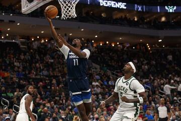 Oct 27, 2021; Milwaukee, Wisconsin, USA; Minnesota Timberwolves center Naz Reid (11) shoots the ball against Milwaukee Bucks forward Bobby Portis (9) during the second quarter at Fiserv Forum. Mandatory Credit: Jeff Hanisch-USA TODAY Sports