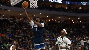 Oct 27, 2021; Milwaukee, Wisconsin, USA; Minnesota Timberwolves center Naz Reid (11) shoots the ball against Milwaukee Bucks forward Bobby Portis (9) during the second quarter at Fiserv Forum. Mandatory Credit: Jeff Hanisch-USA TODAY Sports