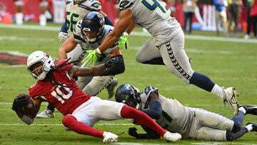 GLENDALE, ARIZONA - NOVEMBER 06: DeAndre Hopkins #10 of the Arizona Cardinals is tackled by Uchenna Nwosu #10 of the Seattle Seahawks in the second quarter of the game at State Farm Stadium on November 06, 2022 in Glendale, Arizona. Norm Hall/Getty Images/AFP
