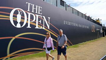 People walk past the new Open Branding during practice for The 150th British Open Golf Championship on The Old Course at St Andrews in Scotland on July 11, 2022. (Photo by Paul ELLIS / AFP) / RESTRICTED TO EDITORIAL USE