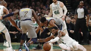 Mar 29, 2019; Boston, MA, USA; Boston Celtics guard Kyrie Irving (11) competes for a loose ball against Indiana Pacers forward Thaddeus Young (21) and guard Darren Collison (2) in the second quarter at TD Garden. Mandatory Credit: David Butler II-USA TODAY Sports