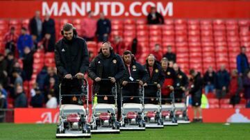 The ground staff cut the grass with their fleet of lawnmowers after the Premier League match between Manchester United and Everton at Old Trafford on September 17, 2017 in Manchester, England.