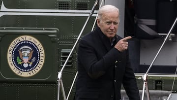 US President Joe Biden points before walking to the Oval office after getting off Marine One on the South Lawn of the White House.