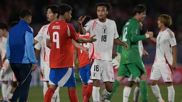 Chile's forward #09 Juan Rossel and Japan's midfielder #18 Nelson Ishiwatari greet each other at the end of the 2025 FIFA U20 World Cup football match between Chile and Japan at the National Stadium in Santiago on September 30, 2025. (Photo by Rodrigo ARANGUA / AFP)