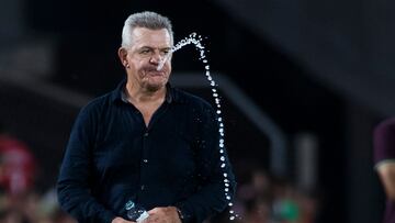 Real Mallorca's Mexican coach Javier Aguirre spits some water during the Spanish Liga football match between RCD Mallorca and Villarreal CF at the Mallorca Son Moix stadium in Palma de Mallorca on August 18, 2023. (Photo by JAIME REINA / AFP)