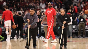 Maintenance staff wipes the floors during a delay in a game between the Chicago Bulls and the Miami Heat at the United Center on January 8, 2026 in Chicago, Illinois.