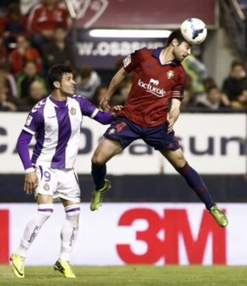 El jugador de Osasuna Miguel Flañod,d., golpea de cabeza el balón ante Javi Guerra, del Valladolid durante el partido que ambos equipos han disputado esta noche en el estadio de El Sadar correspondiente a la trigesimo tercera jornada del campeonato de liga de primera división.