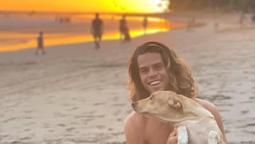 El surfista Kevin Kirby con su perro en la playa