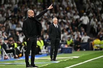 Manchester City's Spanish manager Pep Guardiola (L) gives instructions to his players from the touchline during the UEFA Champions League quarter final first leg football match between Real Madrid CF and Manchester City at the Santiago Bernabeu stadium in Madrid on April 9, 2024. (Photo by JAVIER SORIANO / AFP)