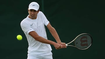 LONDON, ENGLAND - JUNE 28: Daniel Elahi Galan of Colombia plays a backhand against Dominik Koepfer of Germany during their Men's Singles First Round Match on day two of The Championships Wimbledon 2022 at All England Lawn Tennis and Croquet Club on June 28, 2022 in London, England. (Photo by Julian Finney/Getty Images)