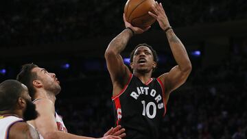 Apr 9, 2017; New York, NY, USA; Toronto Raptors guard DeMar DeRozan (10) shoots the ball over New York Knicks center Kyle O'Quinn (9) and guard Sasha Vujacic (18) during first half at Madison Square Garden. Mandatory Credit: Noah K. Murray-USA TODAY Sports