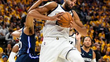 Rudy Gobert of the Utah Jazz grabs a rebound over Spencer Dinwiddie of the Dallas Mavericks.