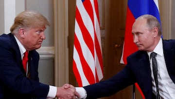 FILE PHOTO: U.S. President Donald Trump and Russia's President Vladimir Putin shake hands as they meet in Helsinki, Finland July 16, 2018. REUTERS/Kevin Lamarque/File Photo