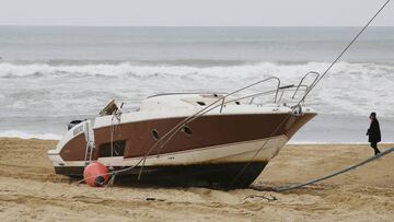 The speedboat belonging to sportswear maker Quiksilver CEO Pierre Agnes lays ashore on the beach of Hossegor, southwestern France, Tuesday, Jan. 30 2018. Authorities have sent boats and helicopters off the coast of southwest France to search for Pierre Agnes, after his empty boat was found washed ashore. (AP Photo)