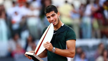 El tenista español Carlos Alcaraz muerde el trofeo de campeón del Mutua Madrid Open tras ganar en la final a Alexander Zverev.