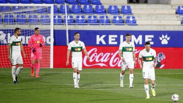 HUESCA, SPAIN - APRIL 09: Ivan Marcone of Elche CF and teammates react after conceding their team&#039;s first goal during the La Liga Santander match between SD Huesca and Elche CF at Estadio El Alcoraz on April 09, 2021 in Huesca, Spain. Sporting stadiu