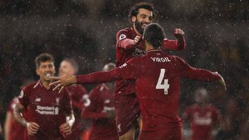 WOLVERHAMPTON, ENGLAND - DECEMBER 21:  Mohmed Salah of Liverpool celebrates with team mates after scoring the opening goal of the game during the Premier League match between Wolverhampton Wanderers and Liverpool FC at Molineux on December 22, 2018 in Wol