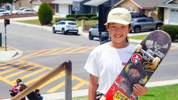 Mei Ozeki con su tabla de skate al lado de una barandilla