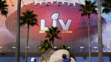 Workers sculpt the Lombardi Trophy out of sand outside of Raymond James Stadium ahead of Super Bowl 55 Thursday, Feb. 4, 2021, in Tampa, Fla. The city is hosting Sunday's Super Bowl football game between the Tampa Bay Buccaneers and the Kansas City Chiefs. (AP Photo/Charlie Riedel)