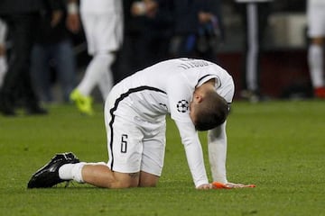 Marco Verratti sits on the pitch at the end of the UEFA Champions League round of 16 second leg football match