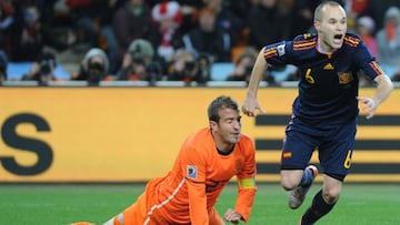 Spain's midfielder Andrés Iniesta (R) celebrates after he scored in extra time as Netherlands' midfielder Rafael van der Vaart reacts during the 2010 FIFA football World Cup final between the Netherlands and Spain on July 11, 2010 at Socc