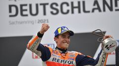 Motorcycling - MotoGP - German Grand Prix - Sachsenring, Hohenstein-Ernstthal, Germany - June 20, 2021 Repsol Honda&#039;s Marc Marquez celebrates with a trophy on the podium after winning the race REUTERS/Matthias Rietschel