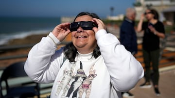 Una mujer se pone unas gafas para poder visualizar el eclipse solar.