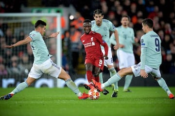 James Rodríguez and Robert Lewandowski battle with Liverpool's Naby Keita.