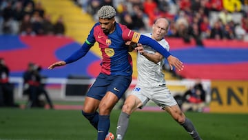 Barcelona's Uruguayan defender #04 Ronald Federico Araujo da Silva (L) tussles with Alaves' Spanish midfielder #18 Jon Guridi during the Spanish league football match between FC Barcelona and Deportivo Alaves at the Estadi Olimpic Lluis Companys in Barcelona on February 2, 2025. (Photo by Josep LAGO / AFP)