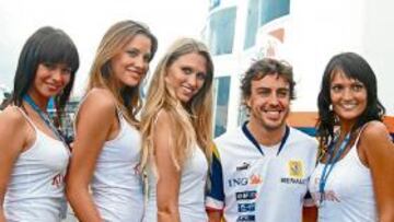 Fernando Alonso posa acompañado de unas modelos.