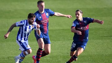 HUESCA, SPAIN - MAY 01: Portu of Real Sociedad battles for possession with Denis Vavro and Jaime Seoane of SD Huesca during the La Liga Santander match between SD Huesca and Real Sociedad at Estadio El Alcoraz on May 01, 2021 in Huesca, Spain. Sporting