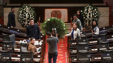 A floral arrangement is carried ahead of the arrival of the coffin of Senator Miguel Uribe Turbay for a tribute at Colombia's Congress, in Bogota, Colombia, August 11, 2025. REUTERS/Luisa Gonzalez