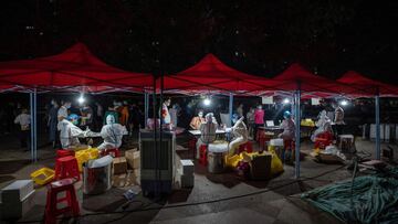 This photo taken on August 3, 2021 shows a resident receiving a nucleic acid test for the coronavirus in Wuhan in China's central Hubei province. (Photo by STR / AFP) / China OUT