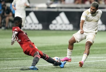 Aug 18, 2021; Atlanta, Georgia, USA; Atlanta United forward Josef Martinez (7) battles for the ball against Toronto FC defender Kemar Lawrence (92) during the second half at Mercedes-Benz Stadium. Mandatory Credit: Dale Zanine-USA TODAY Sports