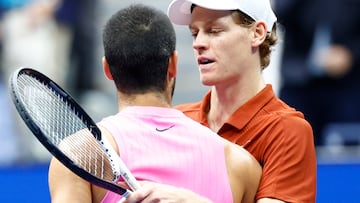 Spain�s Carlos Alcaraz (L) shakes hands with Italy�s Jannik Sinner after winning their men's singles final tennis match on day fifteen of the US Open tennis tournament at the USTA Billie Jean King National Tennis Center in New York City, on September 7, 2025. (Photo by KENA BETANCUR / AFP)