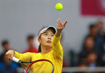 Peng Shuai serves during today's women's singles semi-final in Tianjin.