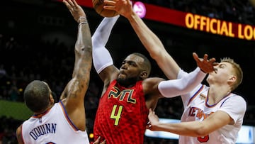 Jan 29, 2017; Atlanta, GA, USA;  Atlanta Hawks forward Paul Millsap (4) is fouled by New York Knicks forward Kristaps Porzingis (6) as he tries to dunk the ball over Knicks center Kyle O&#039;Quinn (9) during the second half at Philips Arena. Mandatory Credit: Butch Dill-USA TODAY Sports