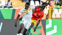 Senegal's forward #18 Ismaila Sarr (L) fights for the ball with Guinea's midfielder #10 Moriba Kourouma during the Africa Cup of Nations (CAN) 2024 group C football match between Guinea and Senegal at Stade Charles Konan Banny in Yamoussoukro on January 23, 2024. (Photo by Issouf SANOGO / AFP)