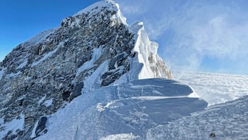 (FILES) This photograph taken on May 31, 2021 shows mountaineers climbing the Hillary Step during their ascend of the South face to summit Mount Everest (8,848.86-metre), in Nepal. The Everest has been climbed by 870 different women of 85 nationalities, some of whom have succeeded several times. The United States, India and China, among the main suppliers of men to the summit, also account for 39% of female ascents. As the sherpas, the Nepalese guides who accompany their clients to the summit, are almost all men, Nepal accounts for more than half the male ascents of Everest. But it accounts for only 9% of women's successes, with 90 ascents by 66 different women. (Photo by Lakpa SHERPA / AFP)