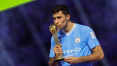 Manchester City's Spanish midfielder #16 Rodrigo Hernandez kisses his golden ball trophy during presentation at the end of the FIFA Club World Cup 2023 football final match against Brazil's Fluminense at King Abdullah Sports City Stadium in Jeddah on December 22, 2023. (Photo by Giuseppe CACACE / AFP)