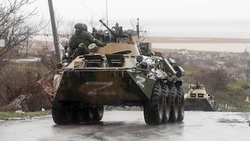 Service members of pro-Russian troops ride an armoured personnel carrier during Ukraine-Russia conflict on a rainy day in the southern port city of Mariupol, Ukraine April 13, 2022.  REUTERS/Alexander Ermochenko