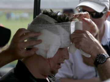 A spectator is assisted by medical staff after getting hit in the head by a drive from Jose Maria Olazabal of Spain on the eighth hole during a practice round in preparation for the 2013 Masters golf tournament at the Augusta National Golf Club in Augusta, Georgia, April 8, 2013. REUTERS/Mark Blinch (UNITED STATES - Tags: SPORT GOLF)